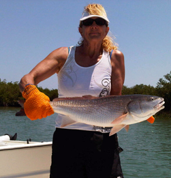 Carla's first big red fish caught in the beautiful Intercoastal Waterway near New Smyrna Beach.
